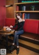 A woman sitting at a table with a plate of food.