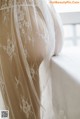 A close up of a white table cloth with lace on it.