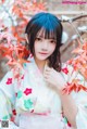 A woman in a kimono posing for a picture.