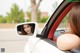 A woman is looking out the window of a car.