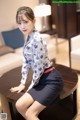 A woman sitting on top of a wooden table.