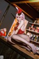 A woman in a bunny costume sitting on a bar.