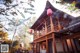 A chinese style building with red lanterns hanging from the roof.