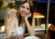 A woman sitting at a table with a plate of food.