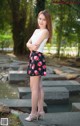 A woman standing on some steps in a park.