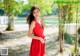 A woman in a red dress posing for a picture.