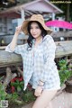 A woman wearing a straw hat posing for a picture.