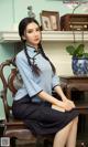 a woman sitting on top of a wooden chair