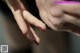 A close up of a woman's hand with a ring on it.