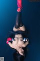 A woman laying on the ground with her legs up in the air.