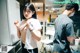 A man and a woman standing in a kitchen next to each other.